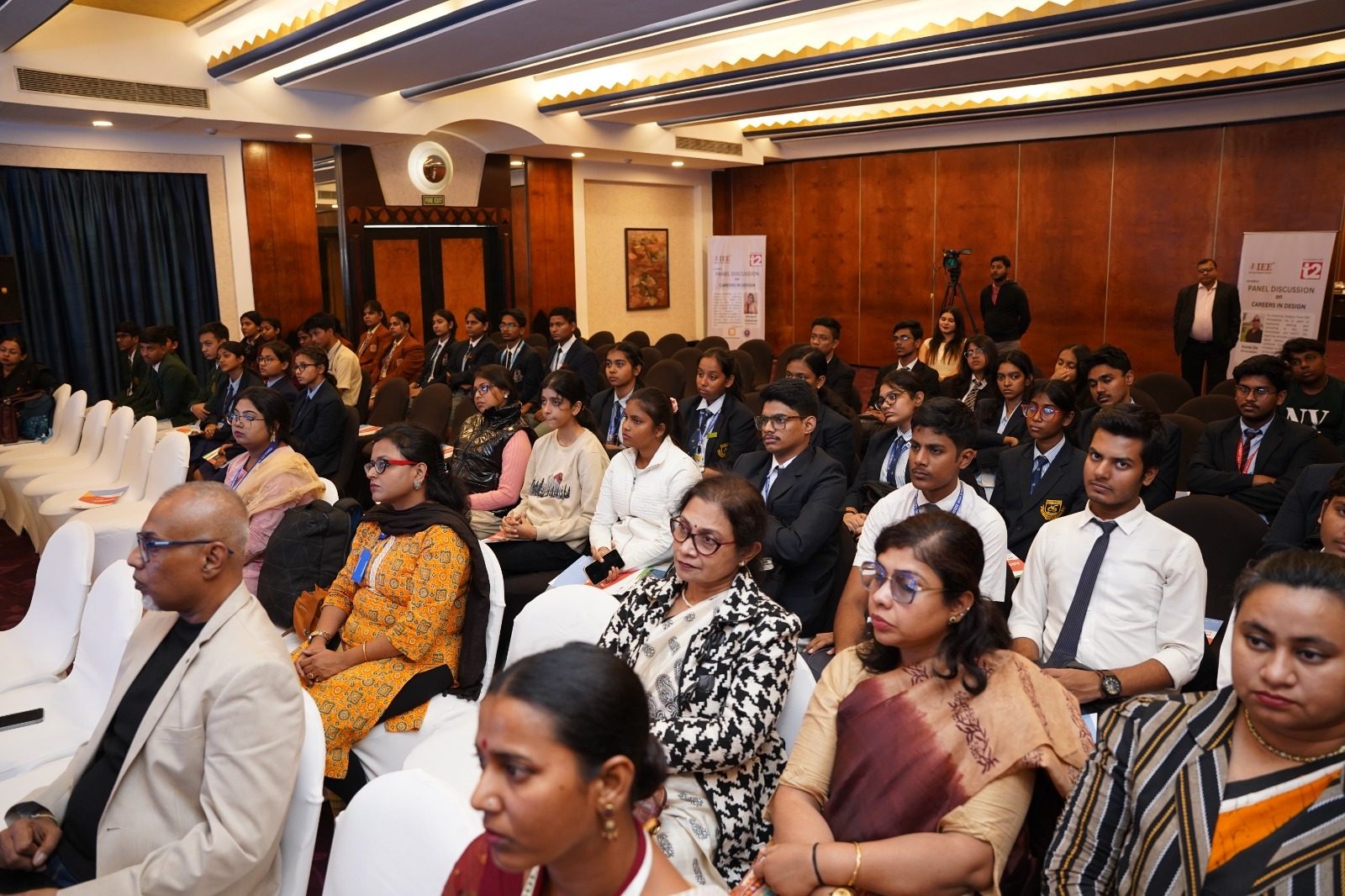 Audience of students and parents at a panel discussion on careers in design